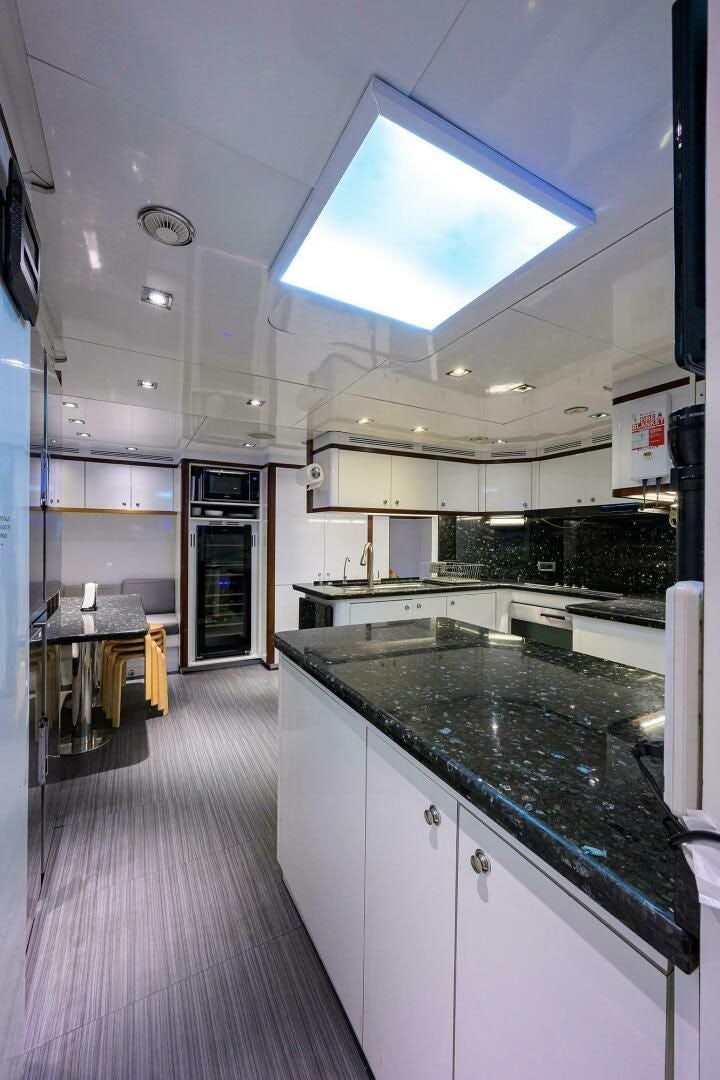 a kitchen with a large island aboard ARTHUR’S WAY Yacht for Sale
