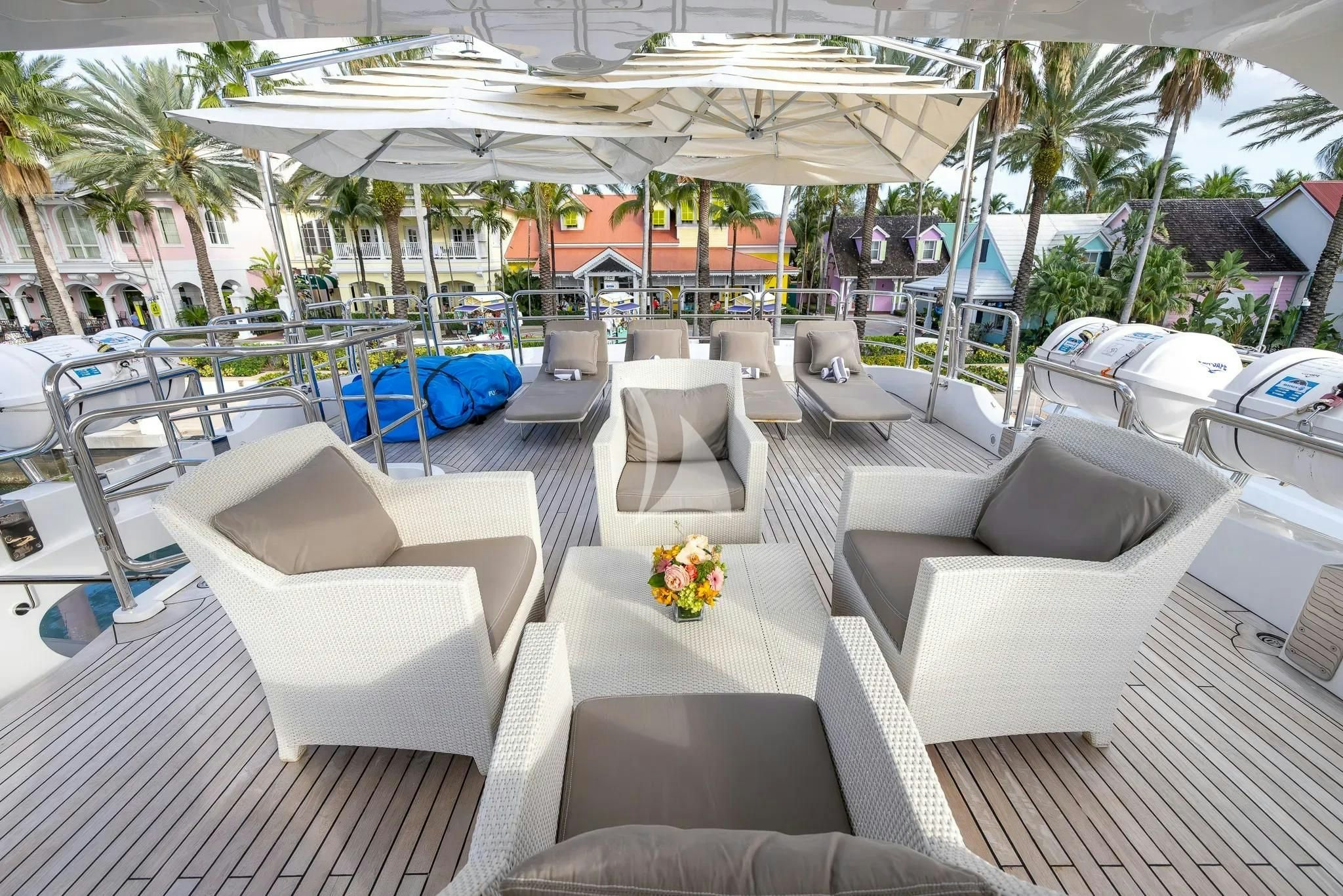 a lounge area with lounge chairs and umbrellas aboard ARTHUR’S WAY Yacht for Sale