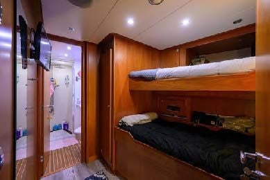 a bedroom with a bed and a closet aboard ARTHUR’S WAY Yacht for Sale