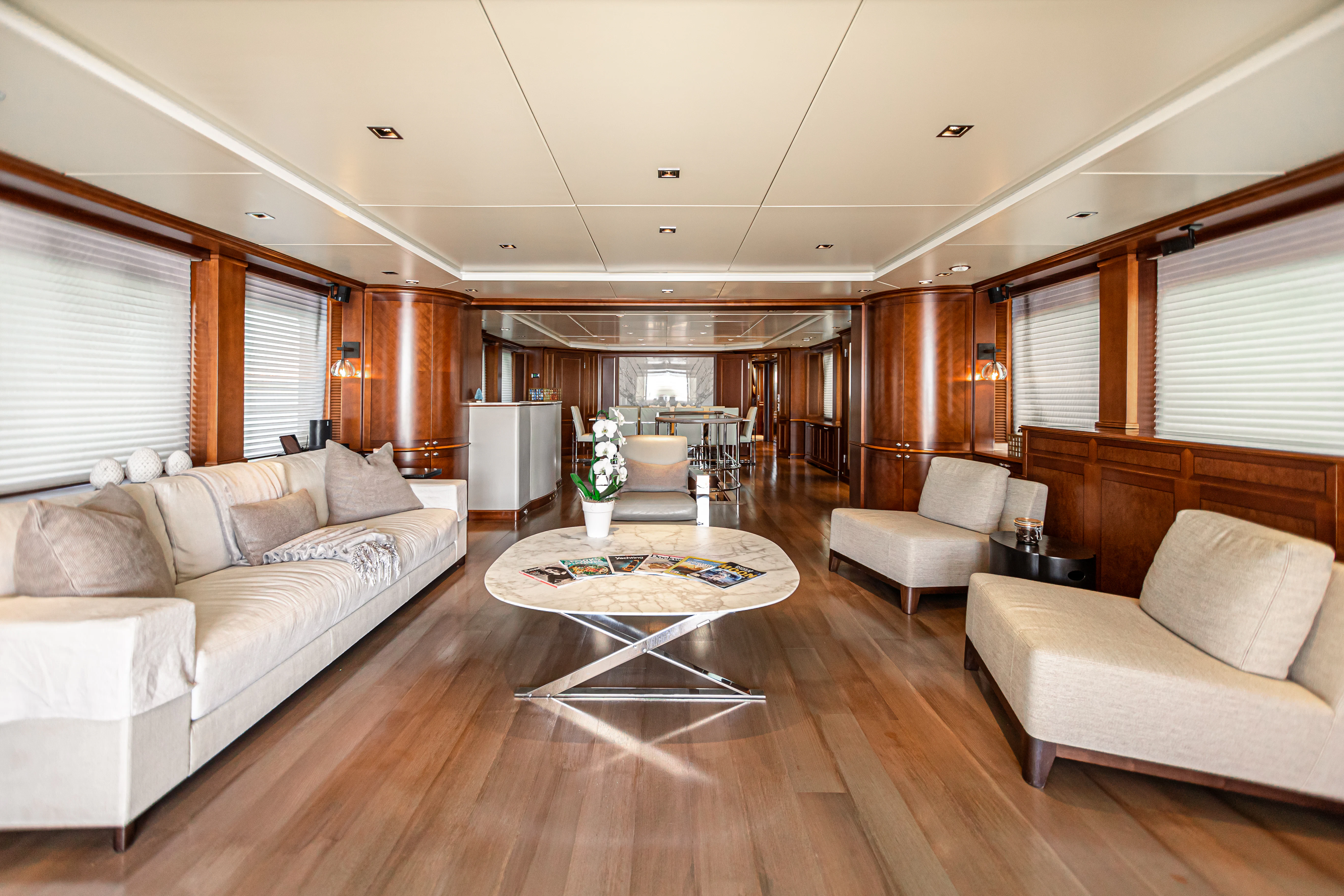 a living room with a table and couches aboard ARTHUR’S WAY Yacht for Sale