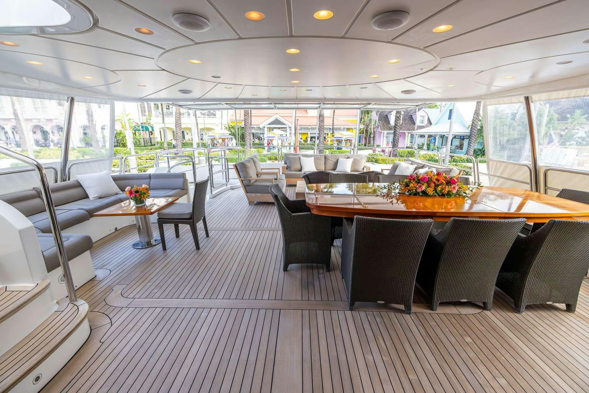 a room with tables and chairs aboard ARTHUR’S WAY Yacht for Sale