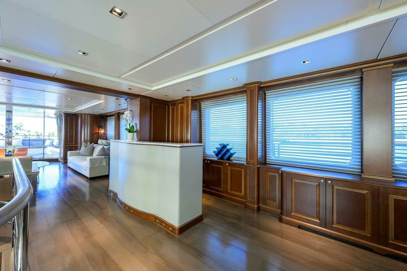a room with a wood floor and cabinets and a white couch aboard ARTHUR’S WAY Yacht for Sale