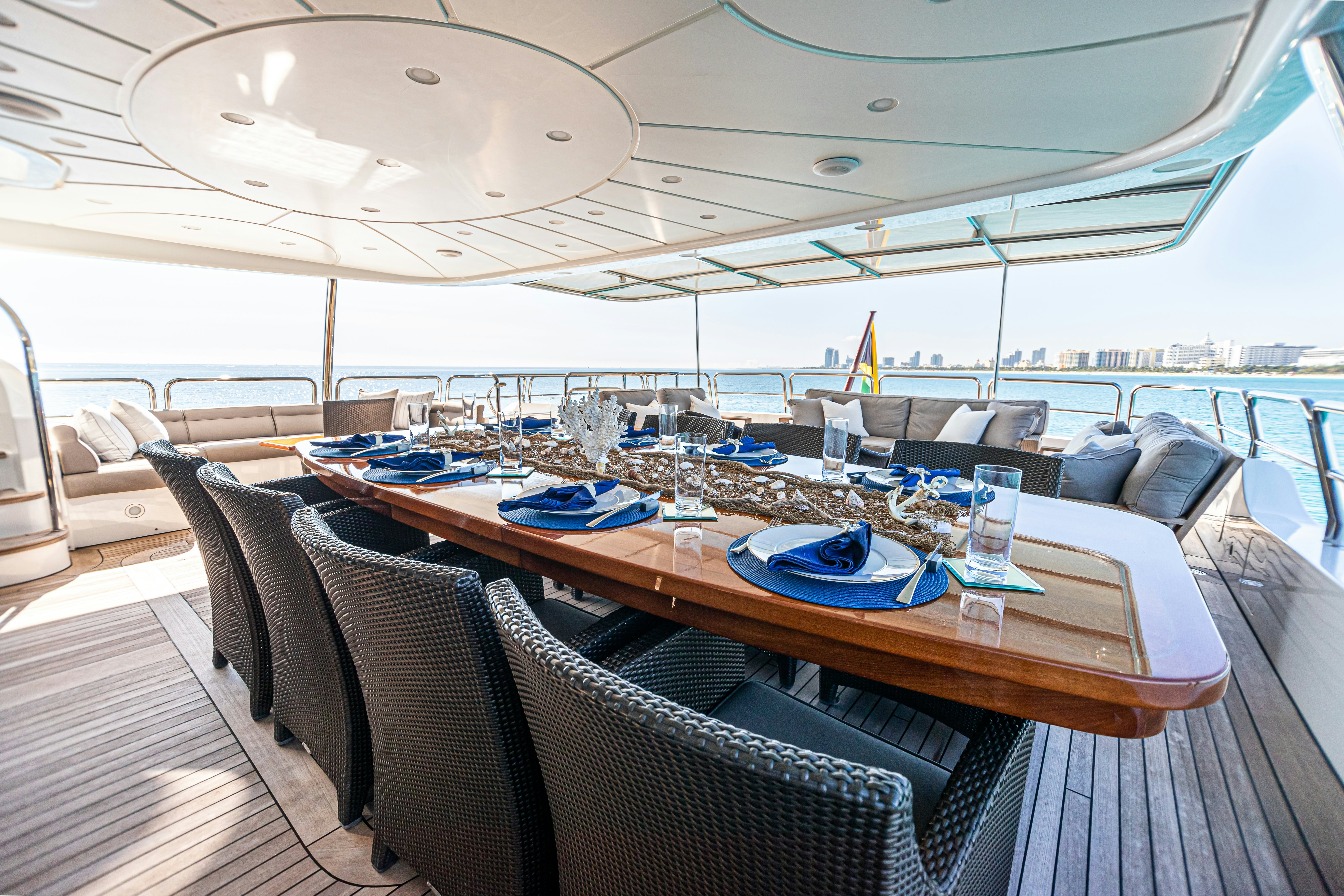 a table with chairs and a large window overlooking a large body of water aboard ARTHUR’S WAY Yacht for Sale