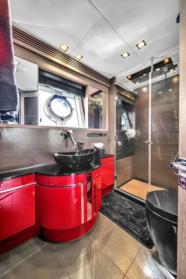 a kitchen with red cabinets aboard SUNSEEKER 115 SPORT YACHT Yacht for Sale