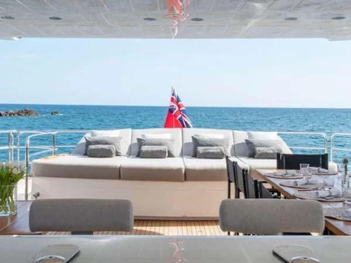 a person sitting on a lounge chair on a beach aboard SUNSEEKER 115 SPORT YACHT Yacht for Sale