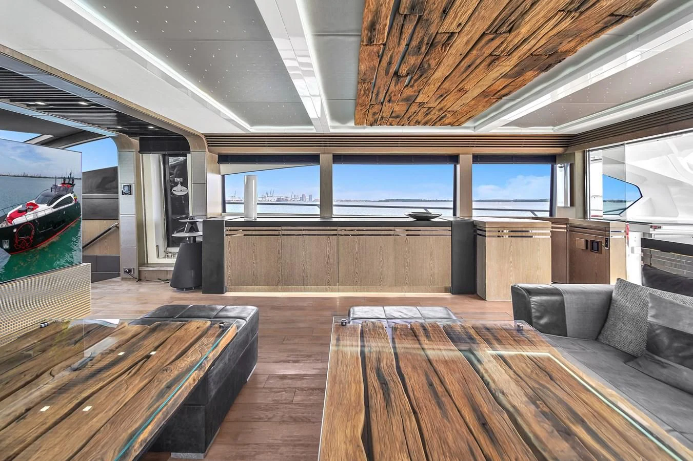 a room with a couch and a large window aboard SUNSEEKER 115 SPORT YACHT Yacht for Sale
