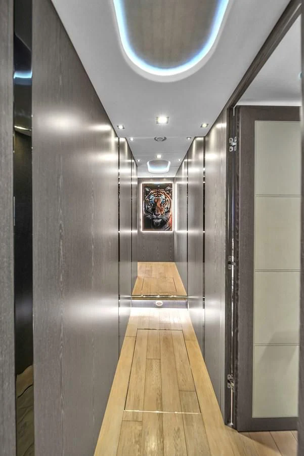 a hallway with a wood floor and a wall with mirrors aboard SUNSEEKER 115 SPORT YACHT Yacht for Sale