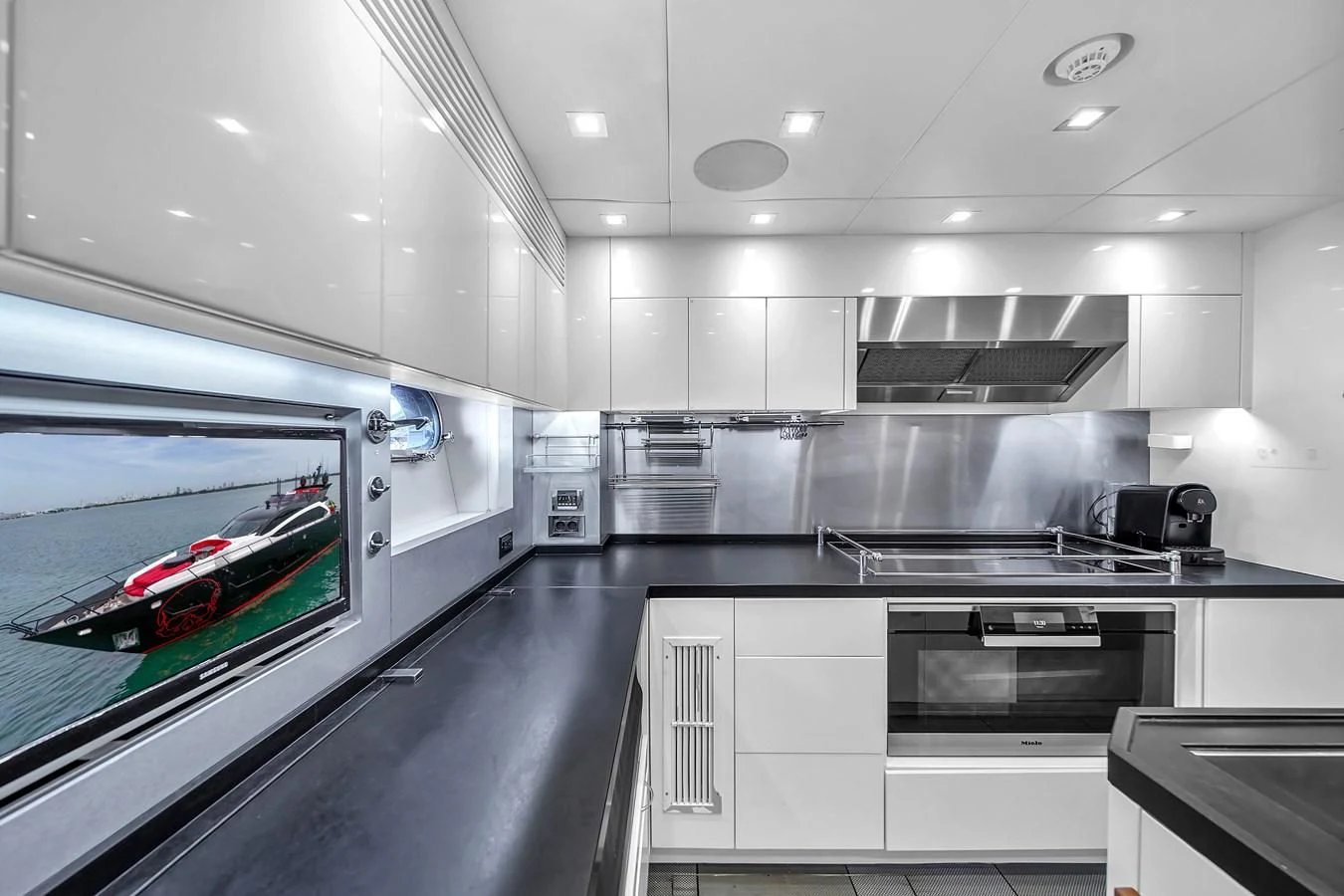 a kitchen with a large window aboard SUNSEEKER 115 SPORT YACHT Yacht for Sale