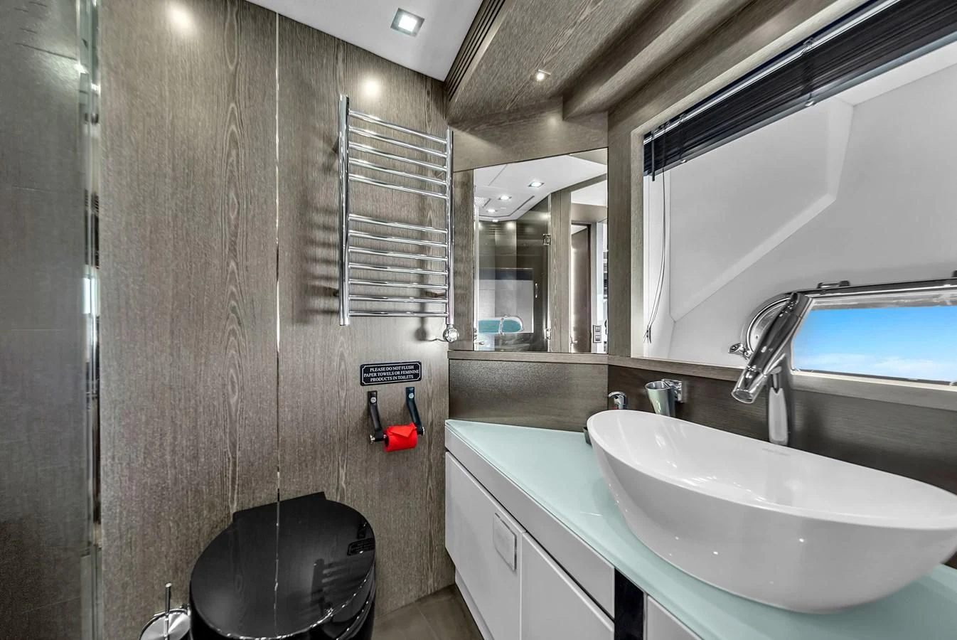 a bathroom with a sink and a mirror aboard SUNSEEKER 115 SPORT YACHT Yacht for Sale