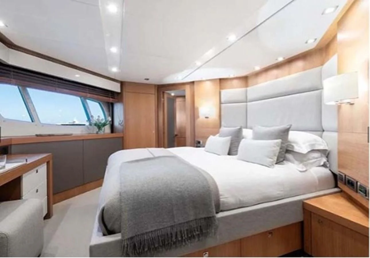 a bed with a white bed aboard SUNSEEKER 115 SPORT YACHT Yacht for Sale