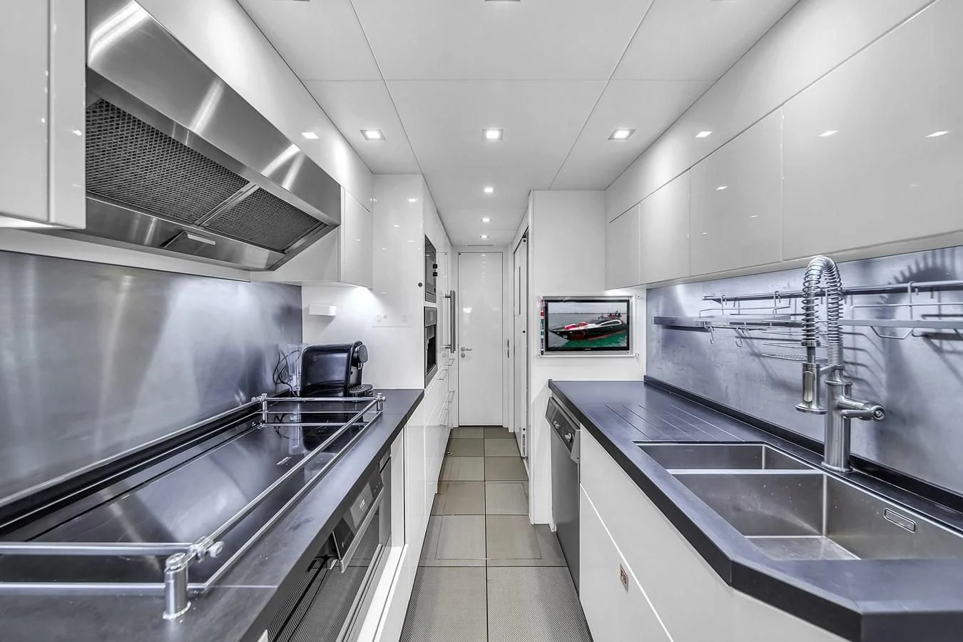 a kitchen with a large sink and a large island aboard SUNSEEKER 115 SPORT YACHT Yacht for Sale