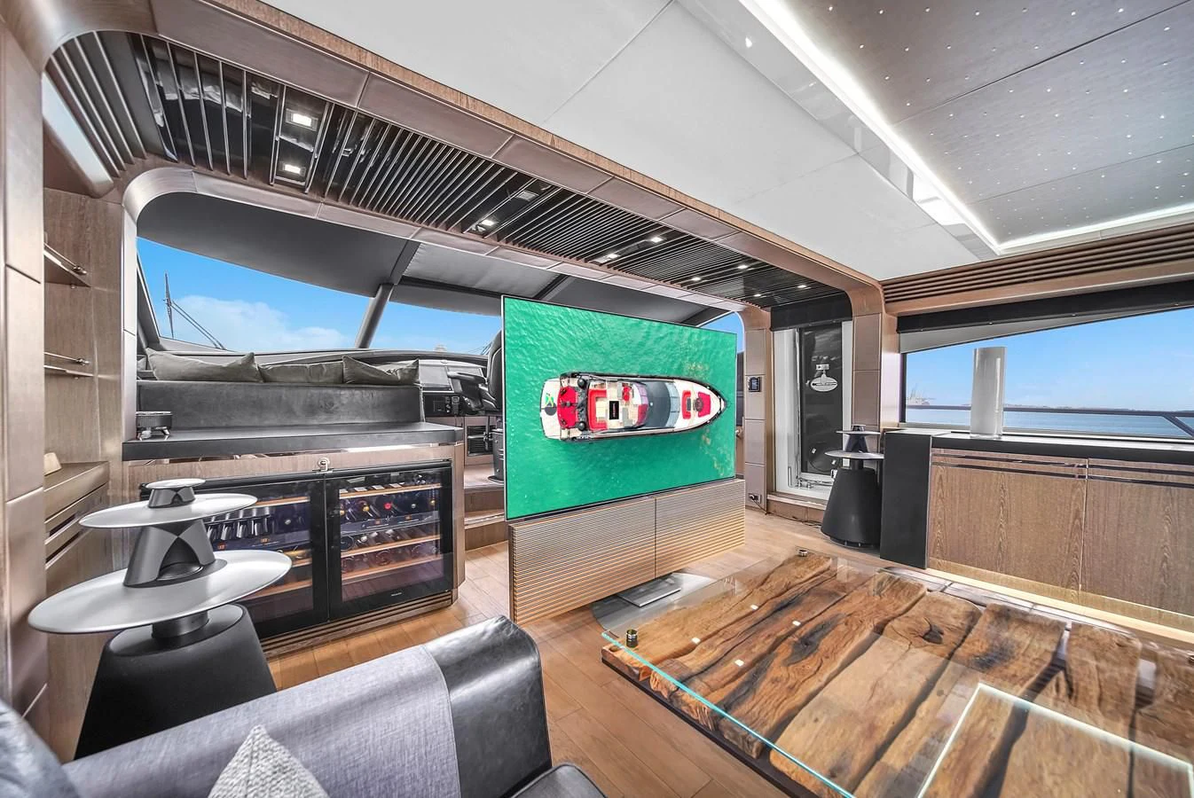 a room with a green screen and a table and a television aboard SUNSEEKER 115 SPORT YACHT Yacht for Sale