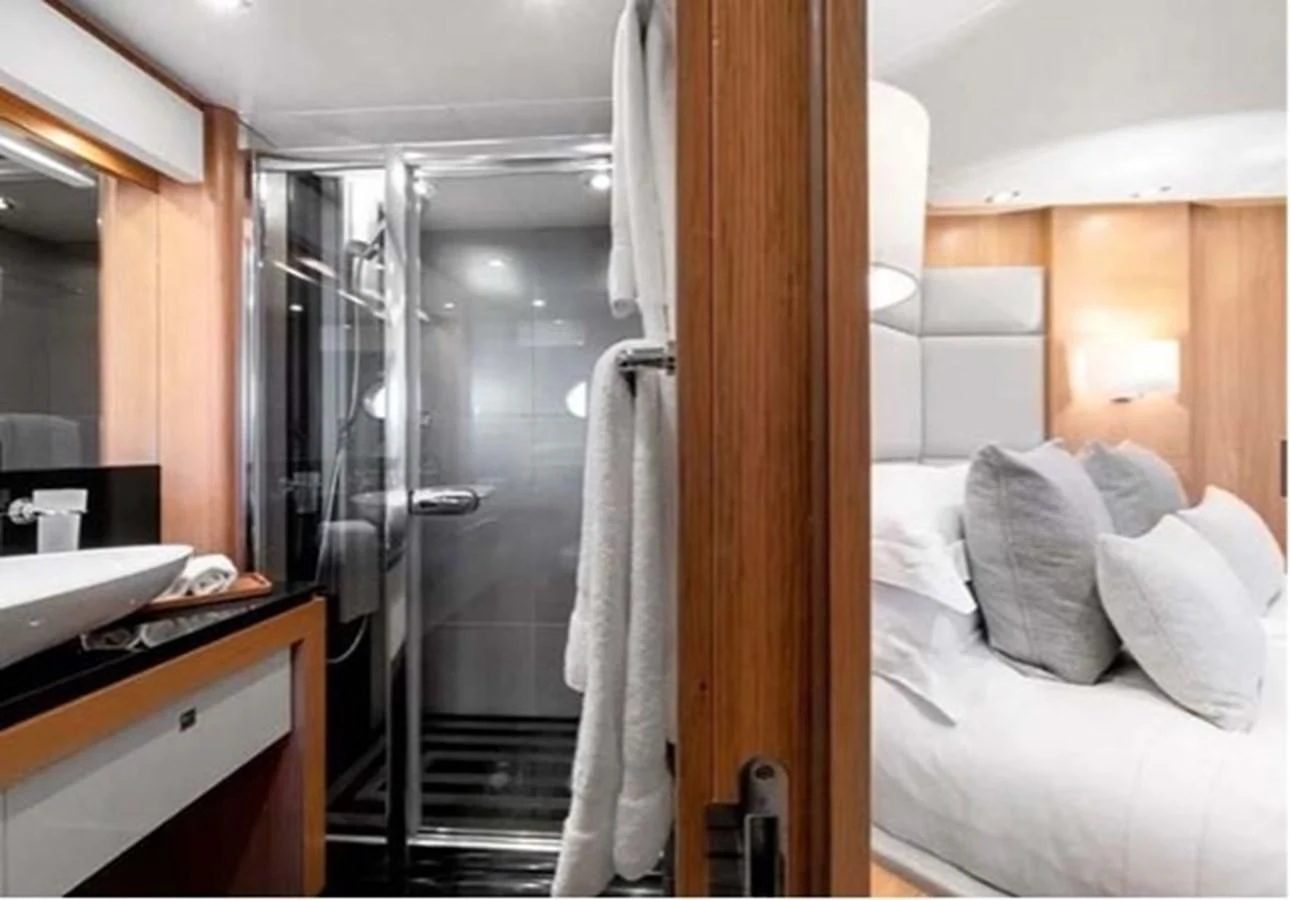 a bathroom with a shower and a bed aboard SUNSEEKER 115 SPORT YACHT Yacht for Sale