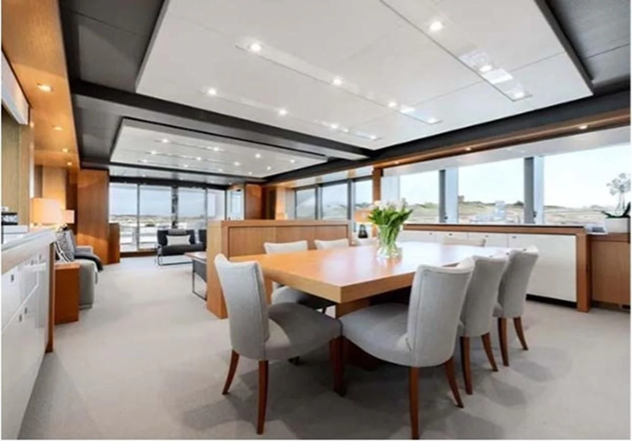 a large room with a table and chairs aboard SUNSEEKER 115 SPORT YACHT Yacht for Sale