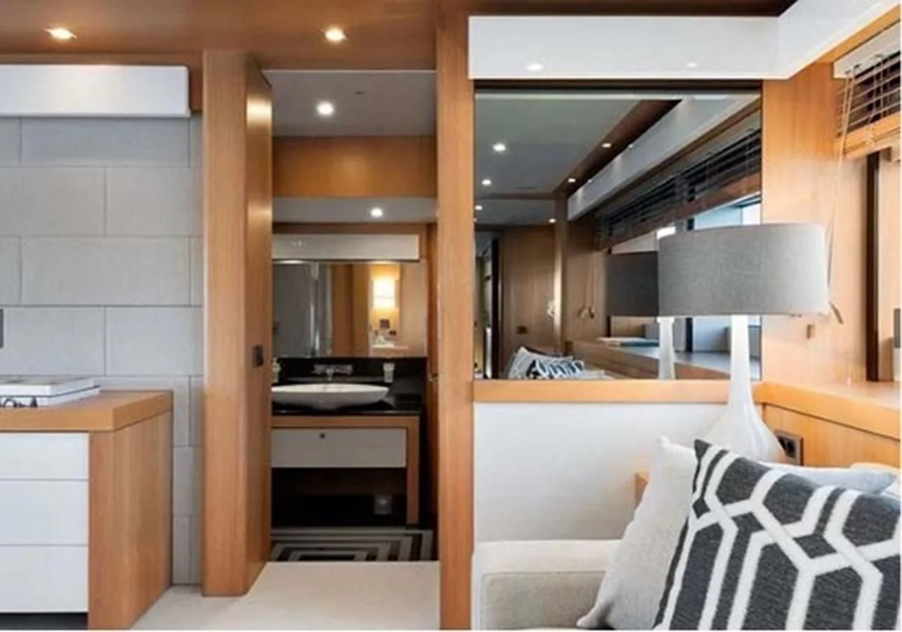 a room with a lamp and a bed aboard SUNSEEKER 115 SPORT YACHT Yacht for Sale