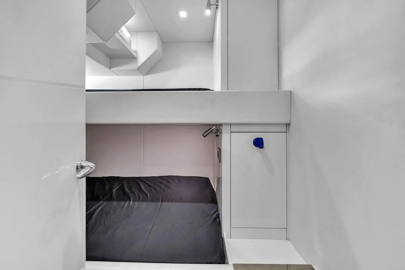 a room with a black couch and a white wall aboard SUNSEEKER 115 SPORT YACHT Yacht for Sale
