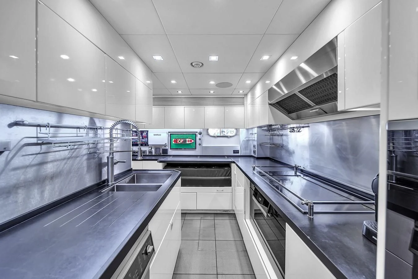 a kitchen with stainless steel appliances aboard SUNSEEKER 115 SPORT YACHT Yacht for Sale