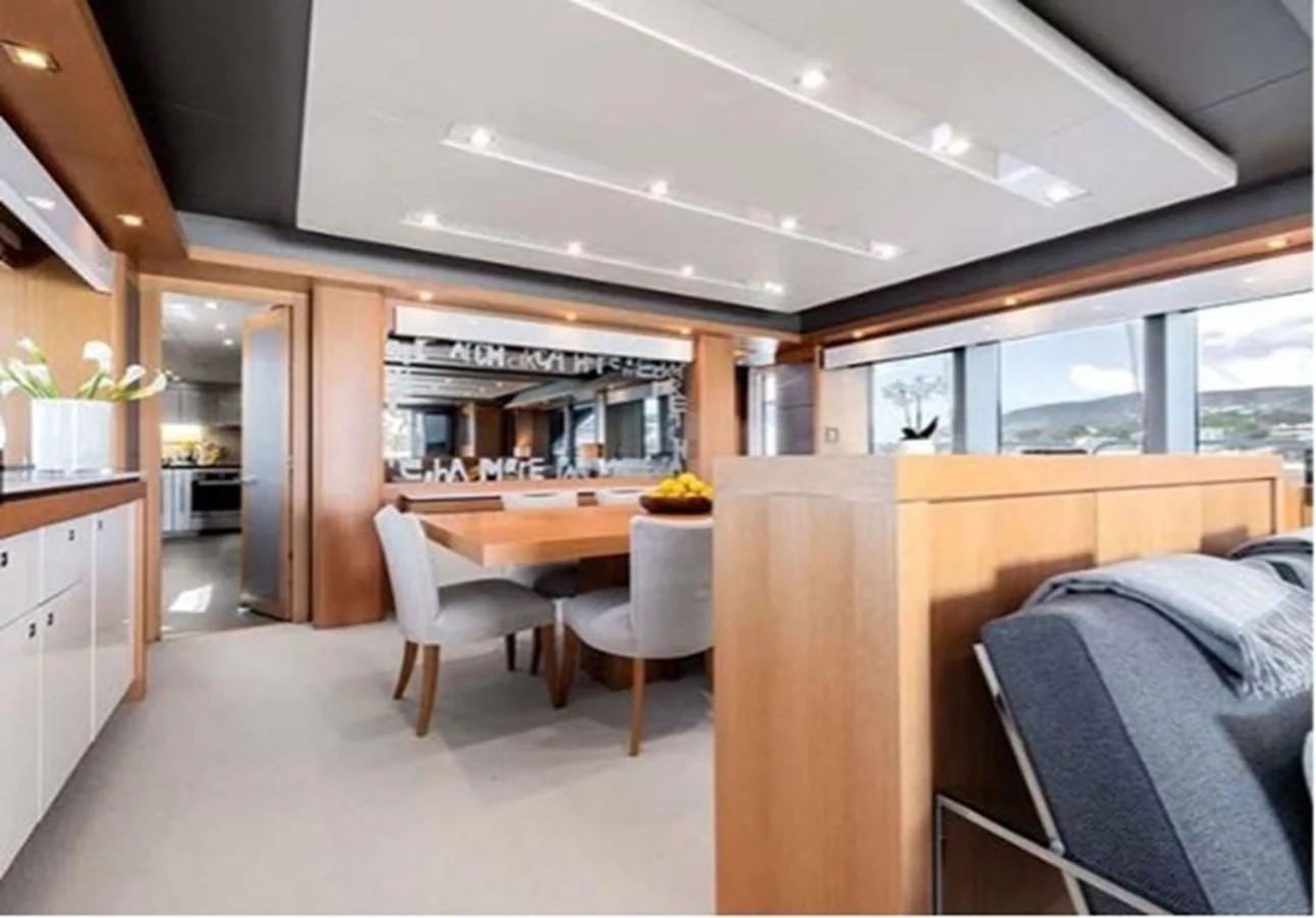 a room with a table and chairs aboard SUNSEEKER 115 SPORT YACHT Yacht for Sale