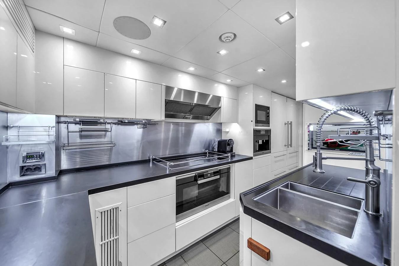 a kitchen with a stainless steel sink aboard SUNSEEKER 115 SPORT YACHT Yacht for Sale