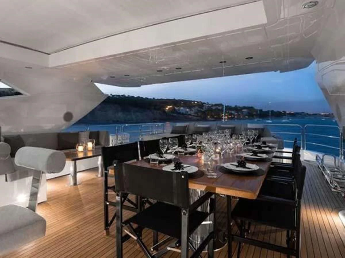 a room with a table and chairs aboard SUNSEEKER 115 SPORT YACHT Yacht for Sale
