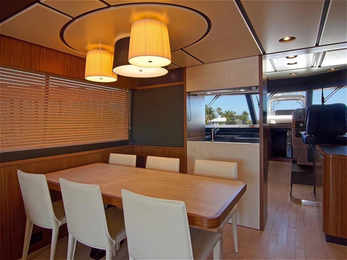 a room with tables and chairs aboard 2017 AZIMUT 66 MAGELLANO Yacht for Sale