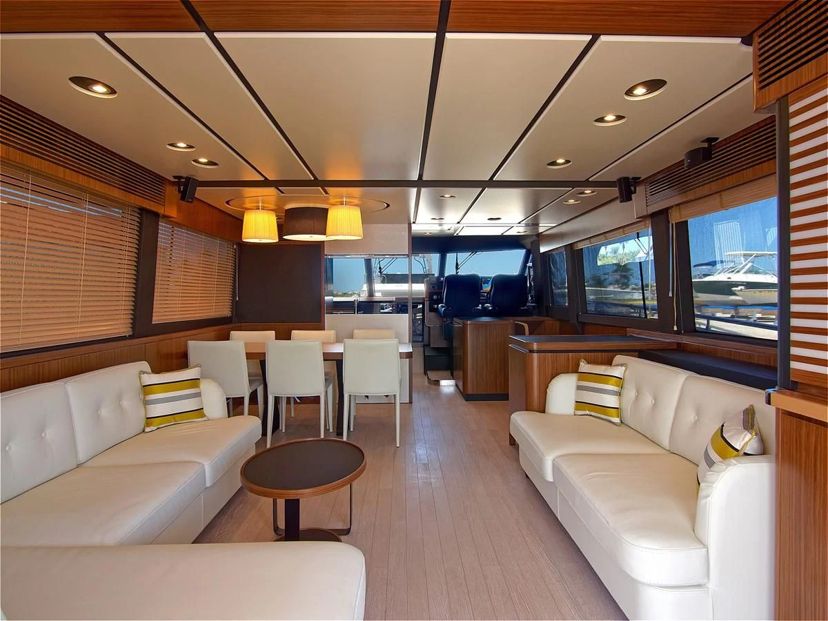 inside of a vehicle with a couch and a table and chairs aboard 2017 AZIMUT 66 MAGELLANO Yacht for Sale