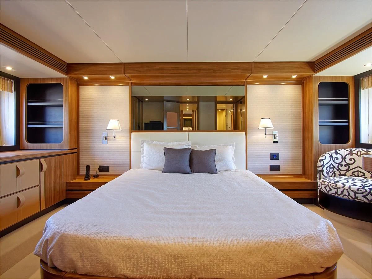 a large bed in a hotel room aboard 2017 AZIMUT 66 MAGELLANO Yacht for Sale