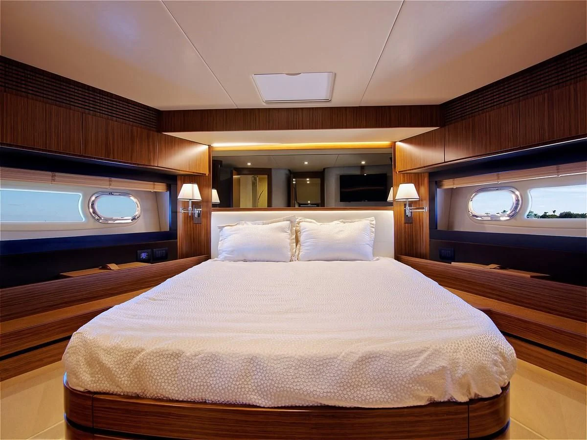 a bed with a white pillow aboard 2017 AZIMUT 66 MAGELLANO Yacht for Sale