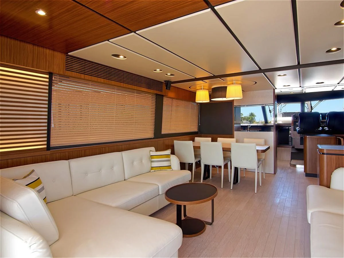 a room with a couch and a table and chairs aboard 2017 AZIMUT 66 MAGELLANO Yacht for Sale
