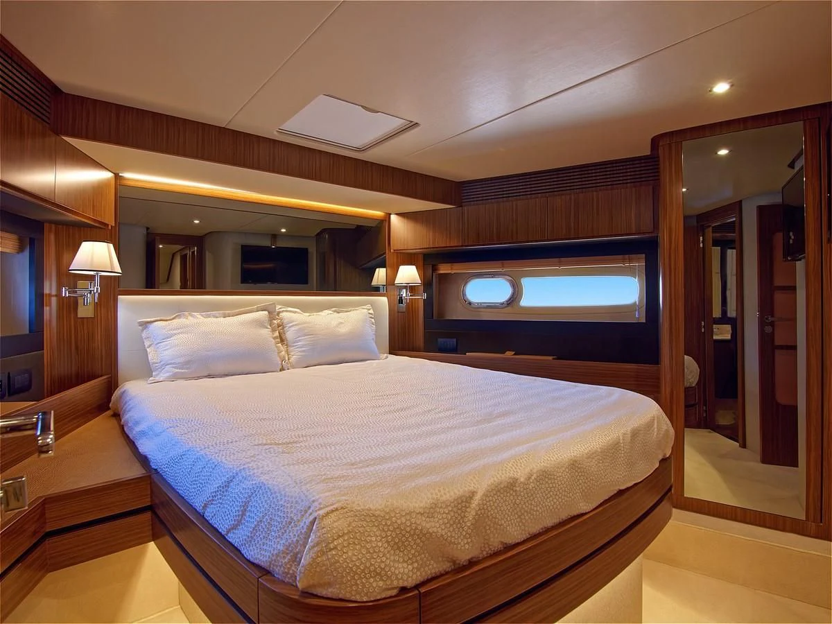 a bed with a white comforter aboard 2017 AZIMUT 66 MAGELLANO Yacht for Sale