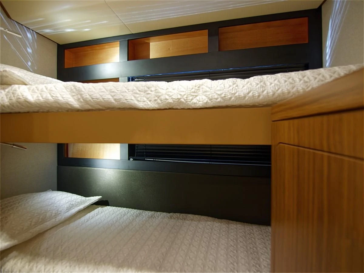 a bed with a television above it aboard 2017 AZIMUT 66 MAGELLANO Yacht for Sale