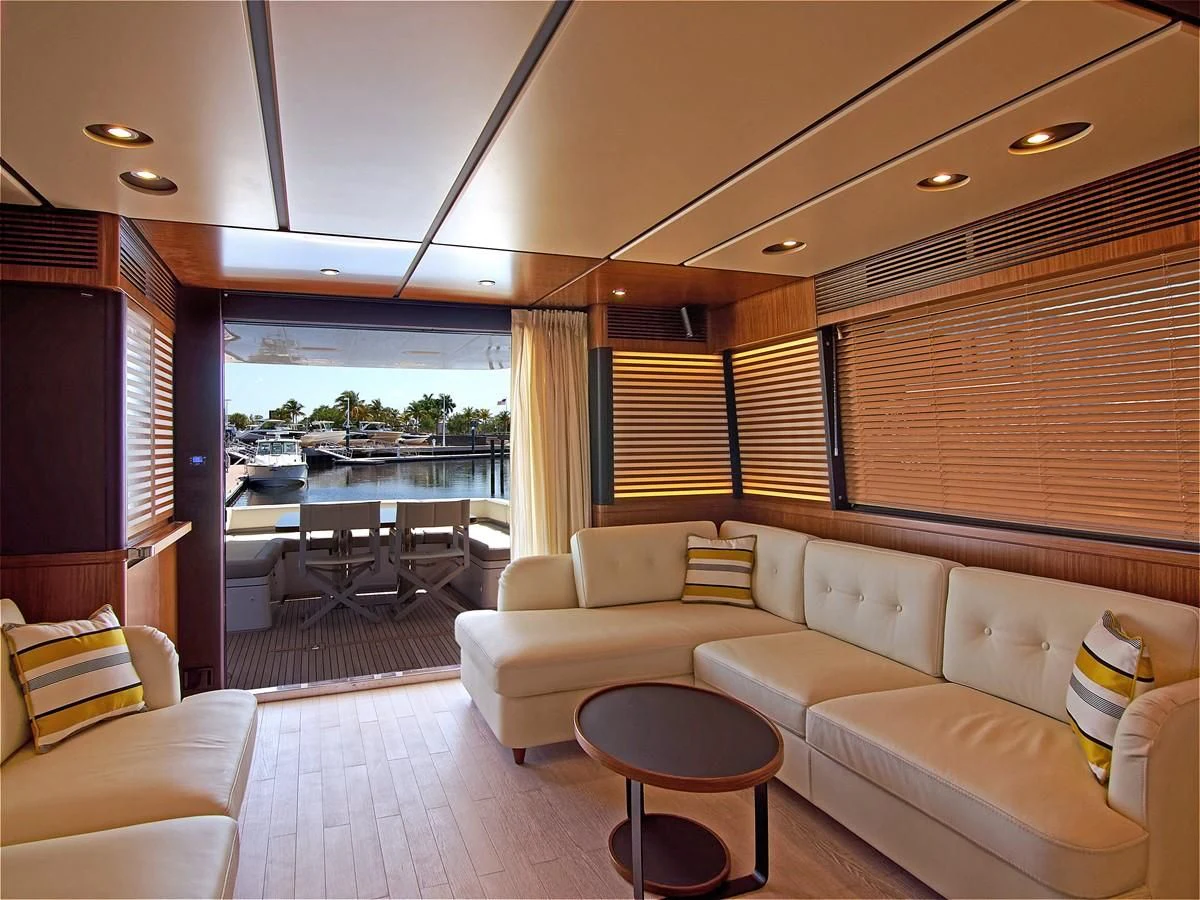 a living room with a couch and a table aboard 2017 AZIMUT 66 MAGELLANO Yacht for Sale
