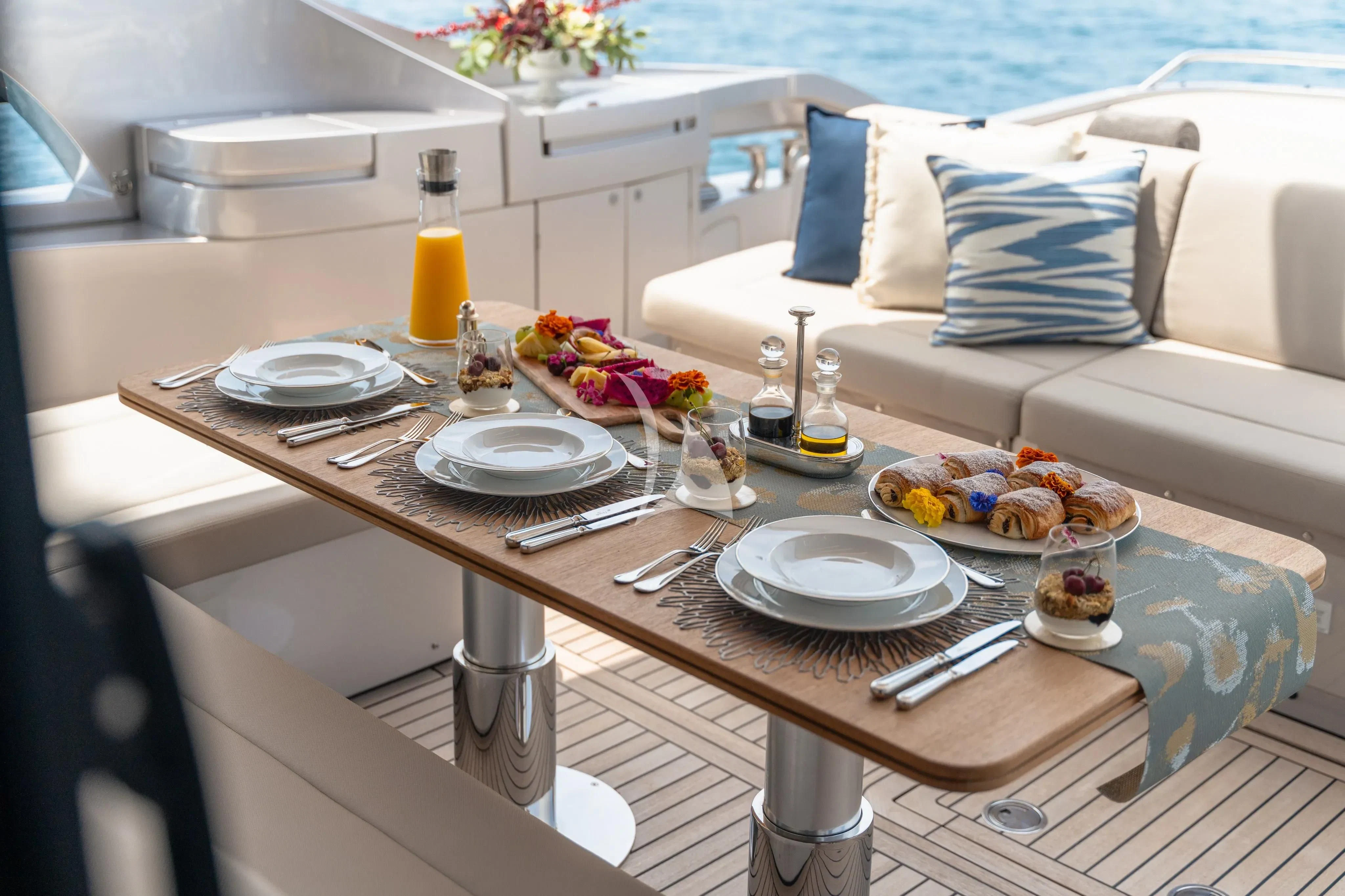 a table with plates and food on it aboard CHERRY Yacht for Charter