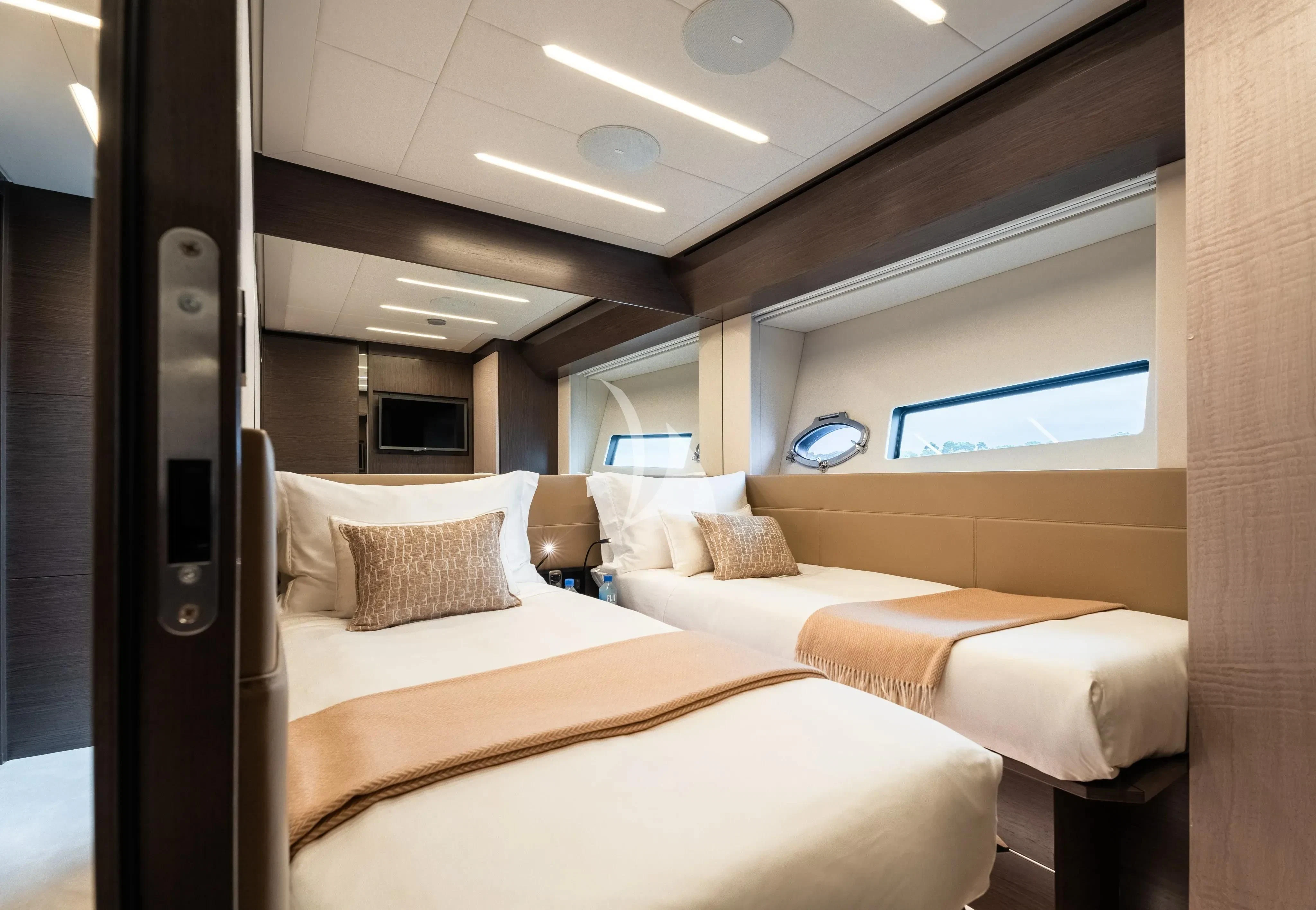 a room with a bed and a tv aboard CHERRY Yacht for Charter