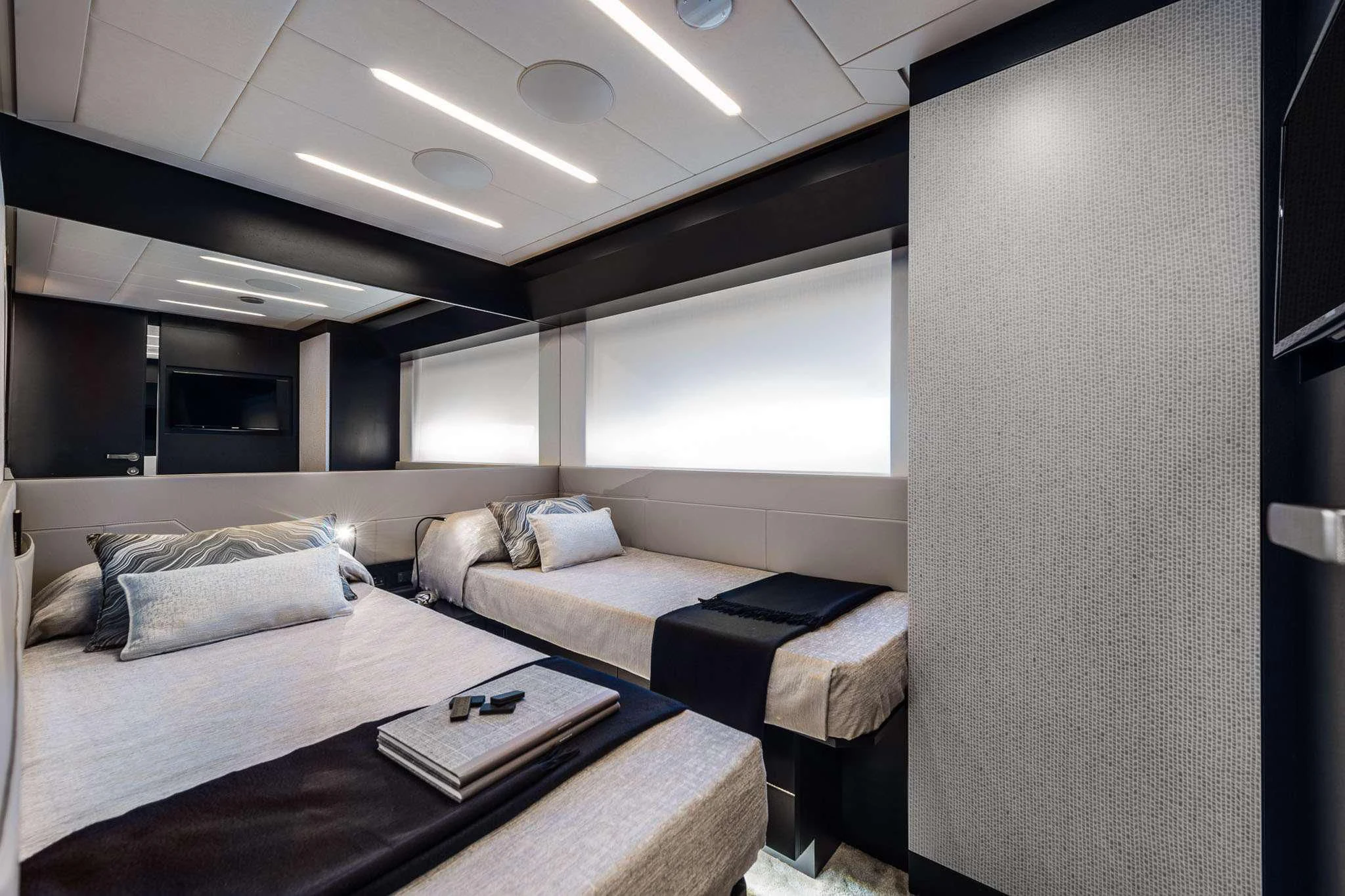 a room with a bed and a table aboard CHERRY Yacht for Charter