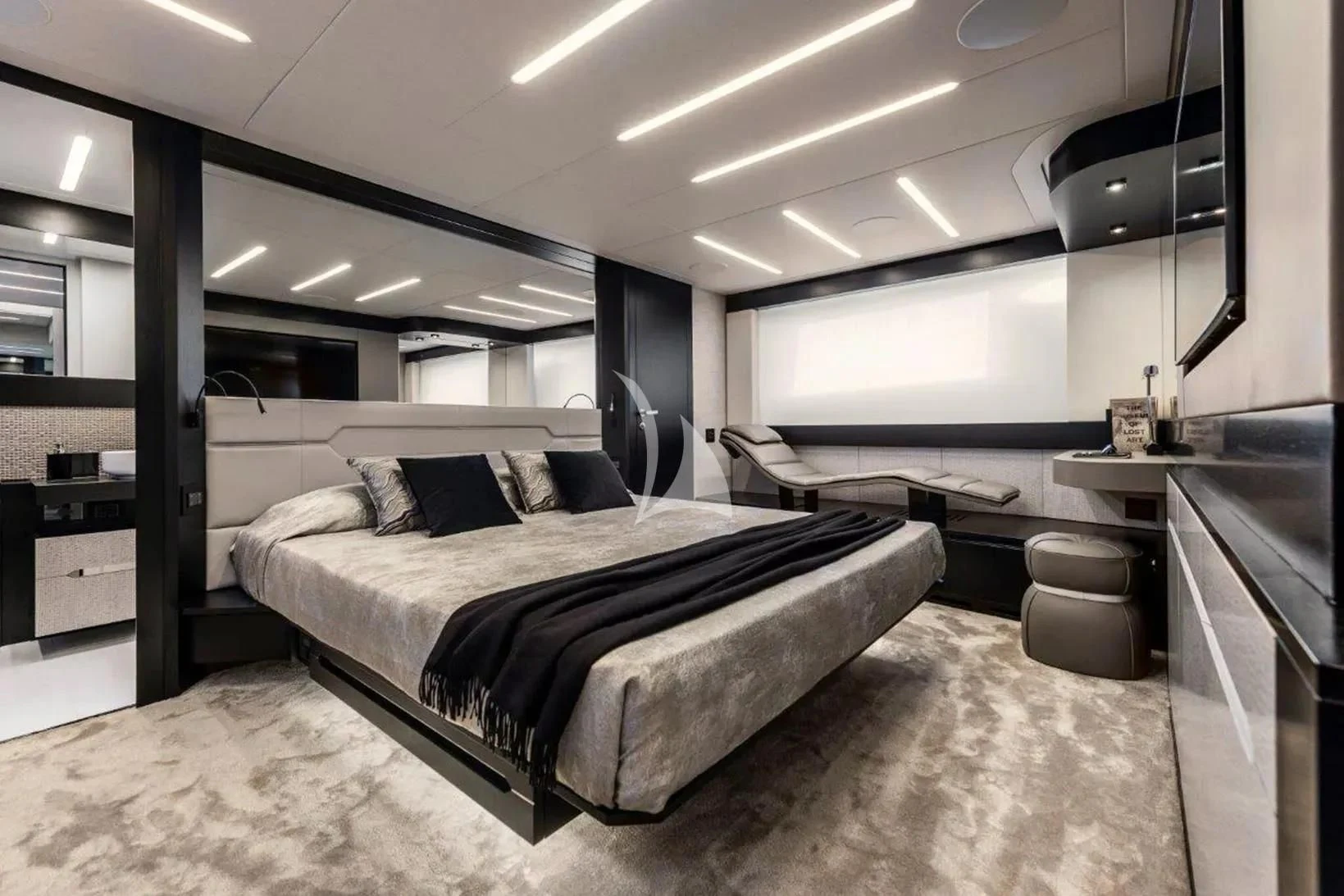 a room with a bed and desk aboard CHERRY Yacht for Charter