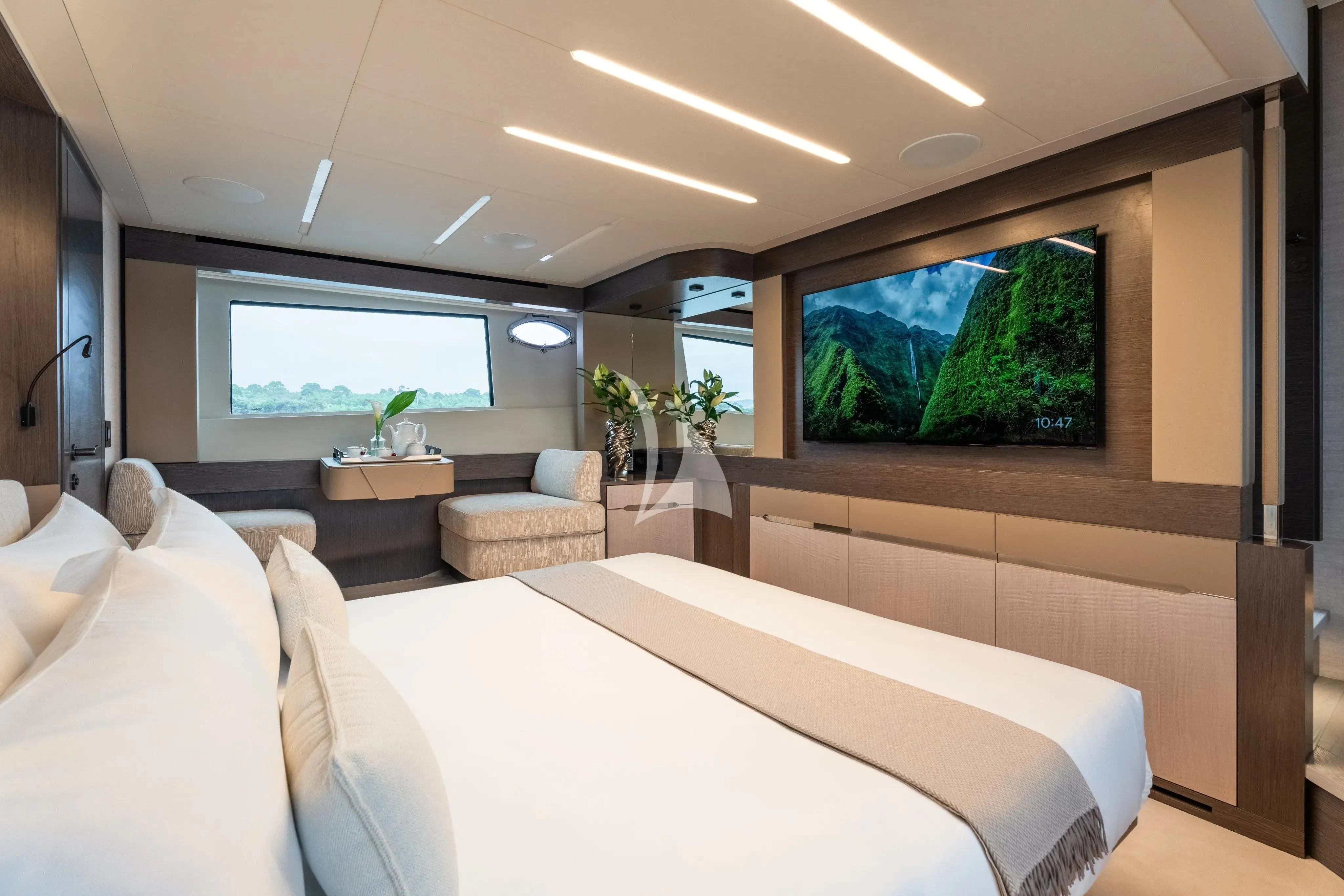 a room with a bed and a tv on the wall aboard CHERRY Yacht for Charter