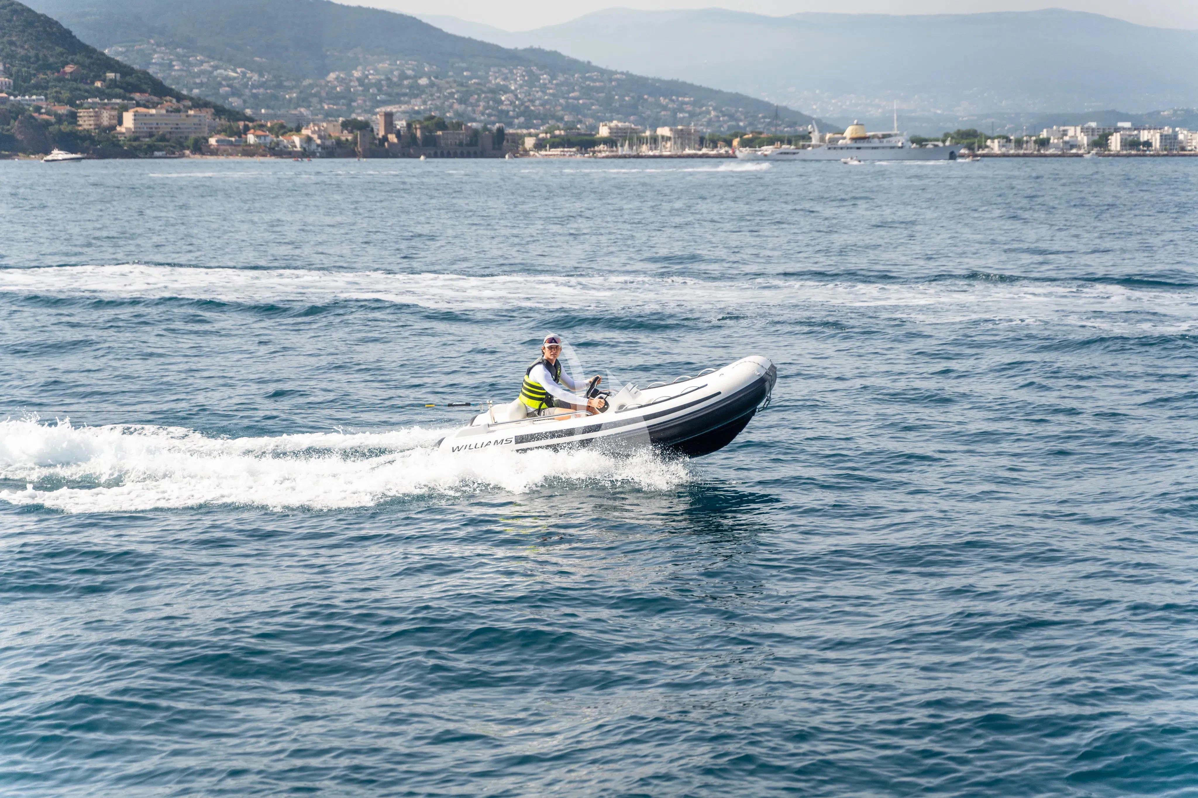 a man and a woman in a boat on the water aboard CHERRY Yacht for Charter
