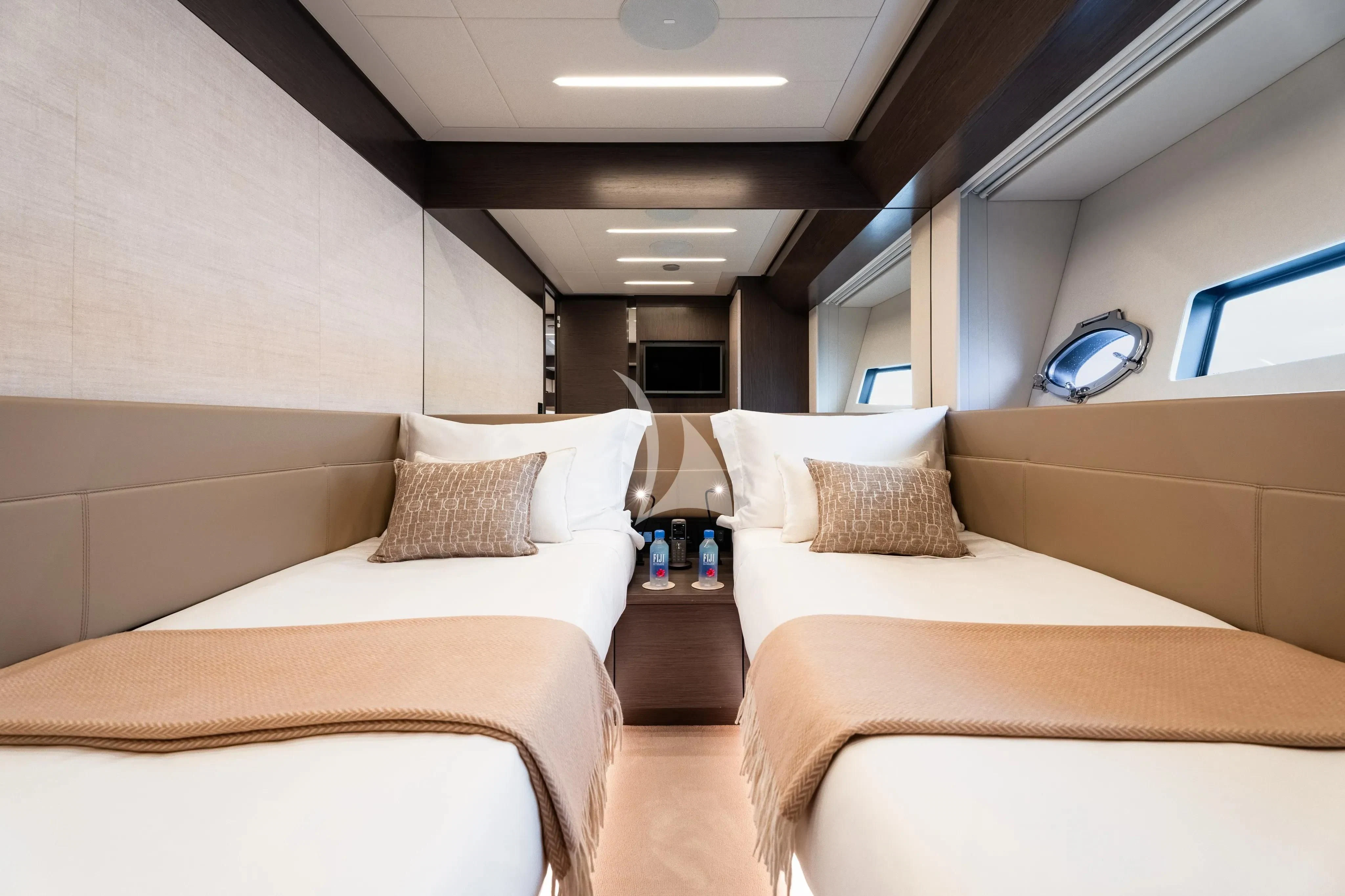 a room with beds and a mirror aboard CHERRY Yacht for Charter