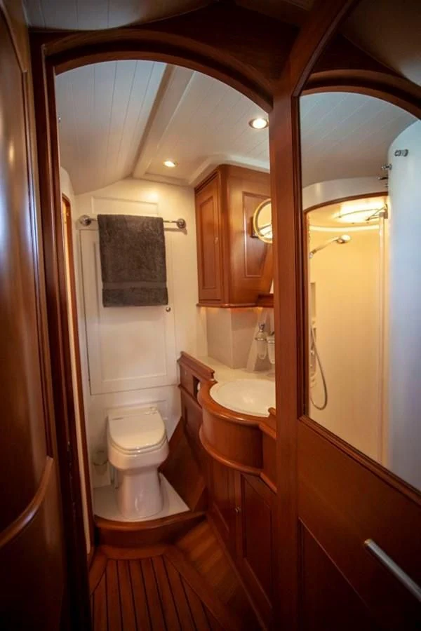 a bathroom with a sink toilet and a mirror aboard SWEET EMOTION Yacht for Sale