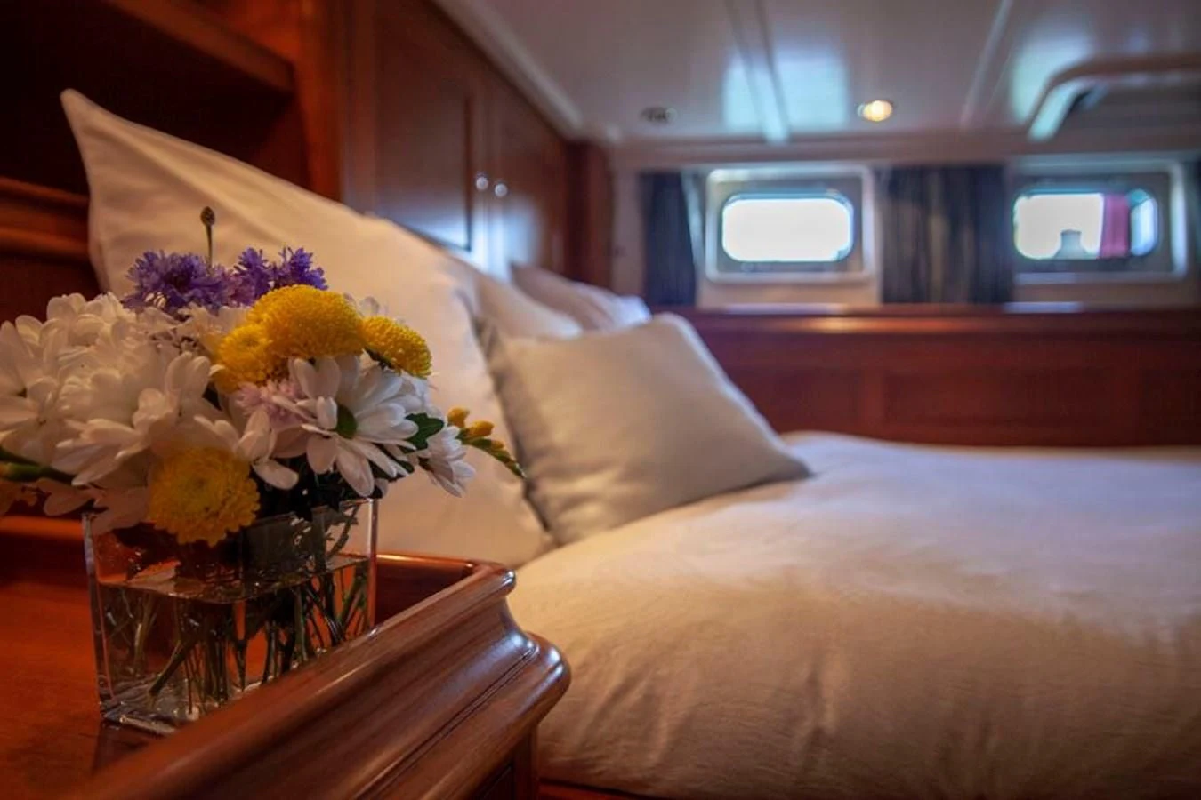 a table with a vase of flowers on it aboard SWEET EMOTION Yacht for Sale