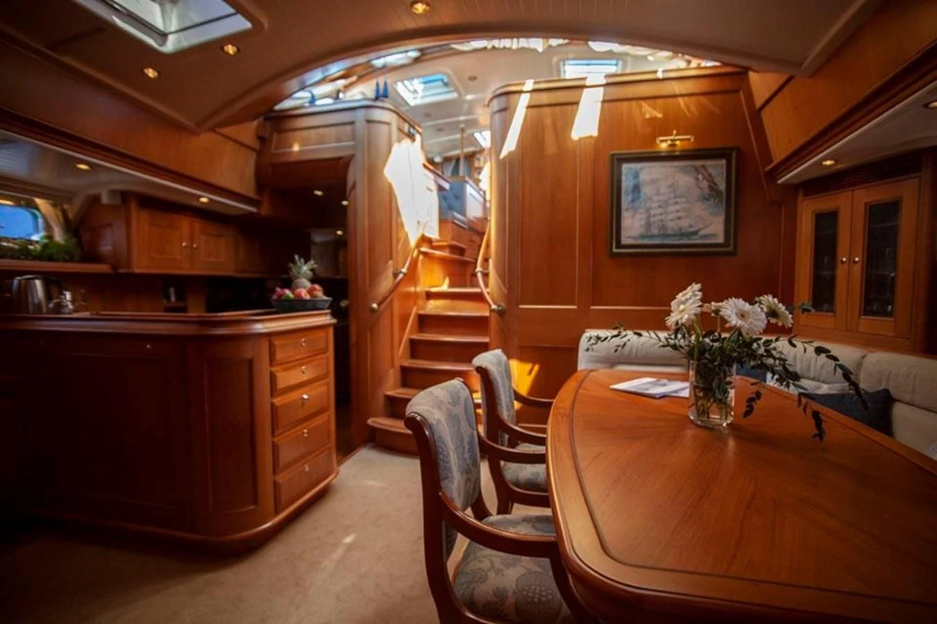 a kitchen with a staircase and a table aboard SWEET EMOTION Yacht for Sale
