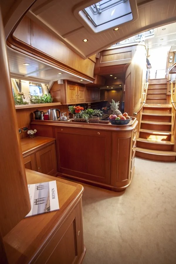 a kitchen with wooden cabinets aboard SWEET EMOTION Yacht for Sale