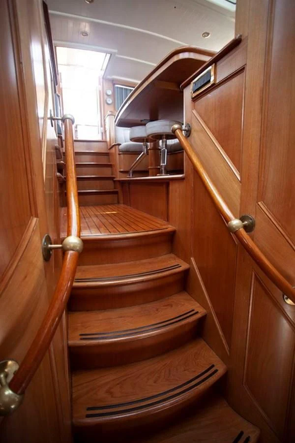 a wooden staircase with wood railings aboard SWEET EMOTION Yacht for Sale