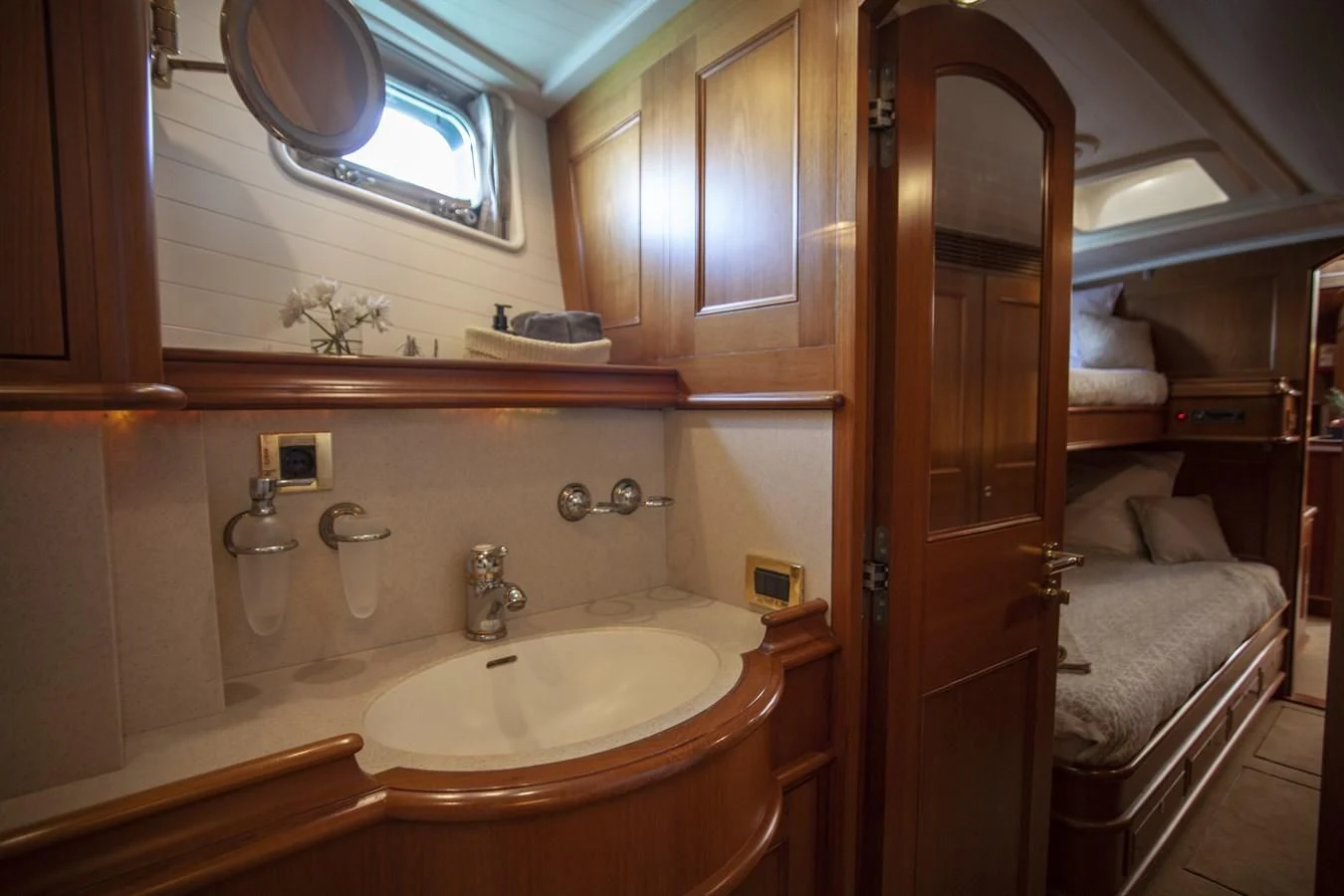 a bathroom with a sink and a bed aboard SWEET EMOTION Yacht for Sale