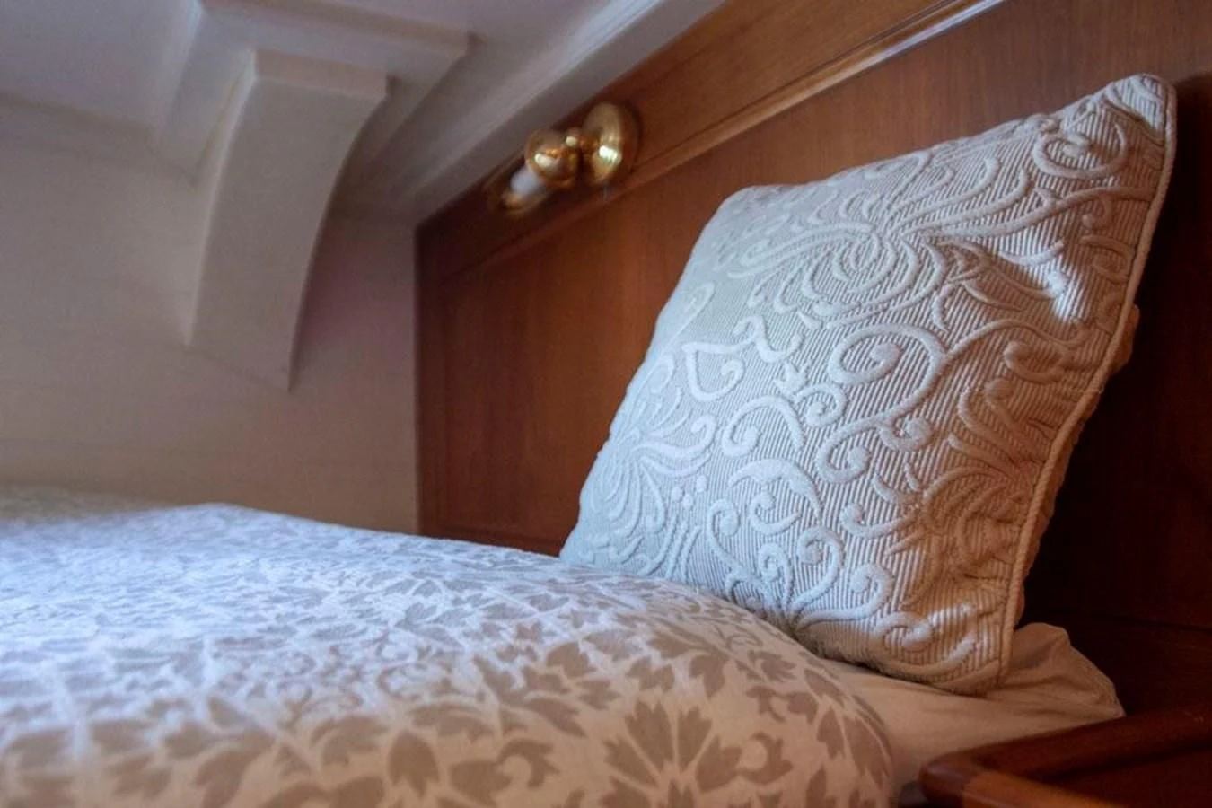 a bed with a white comforter aboard SWEET EMOTION Yacht for Sale