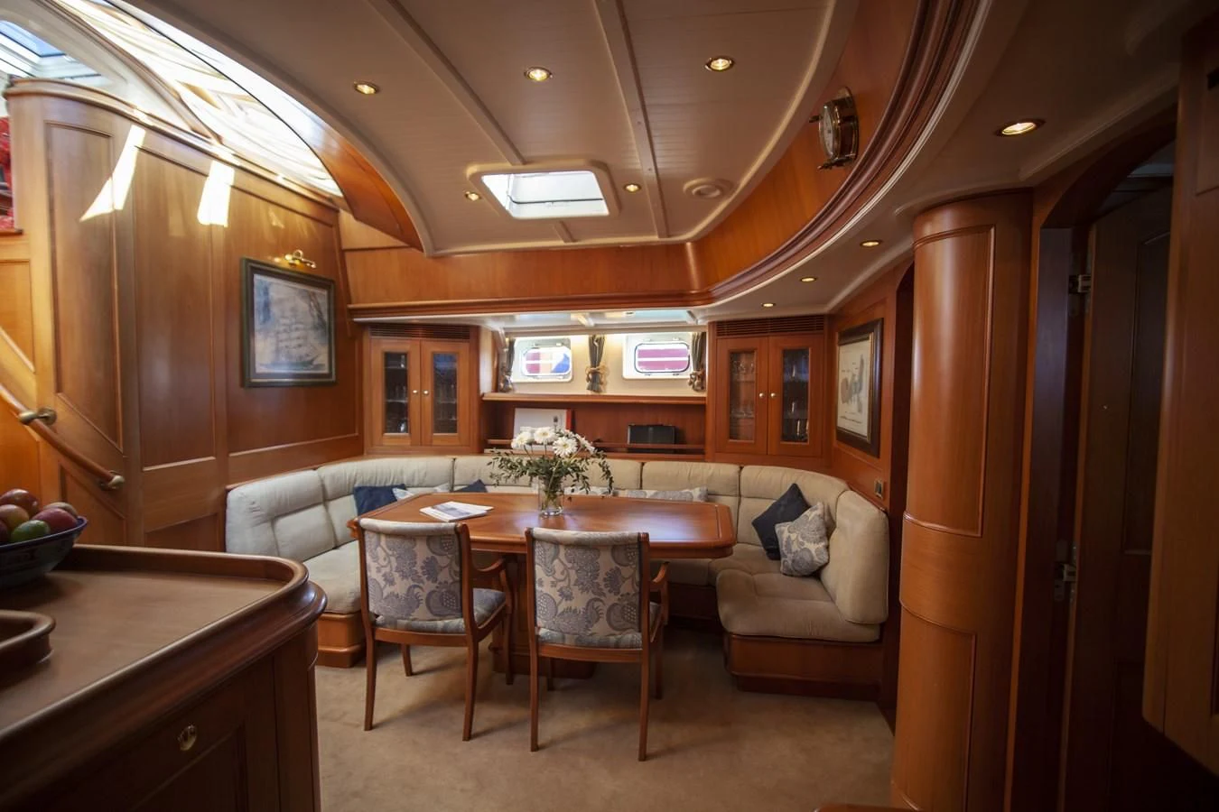 a living room with a table and chairs aboard SWEET EMOTION Yacht for Sale