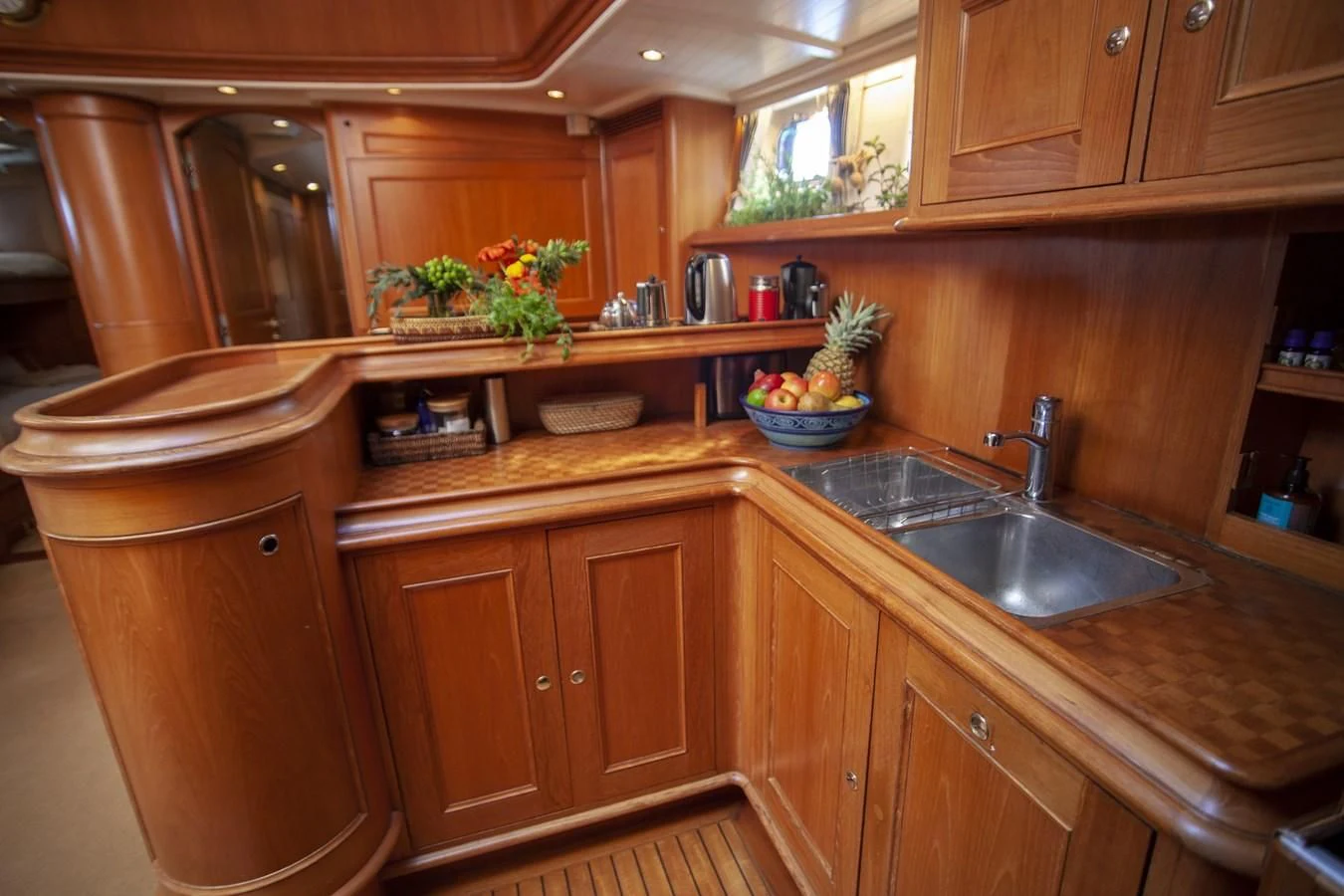 a kitchen with wooden cabinets aboard SWEET EMOTION Yacht for Sale