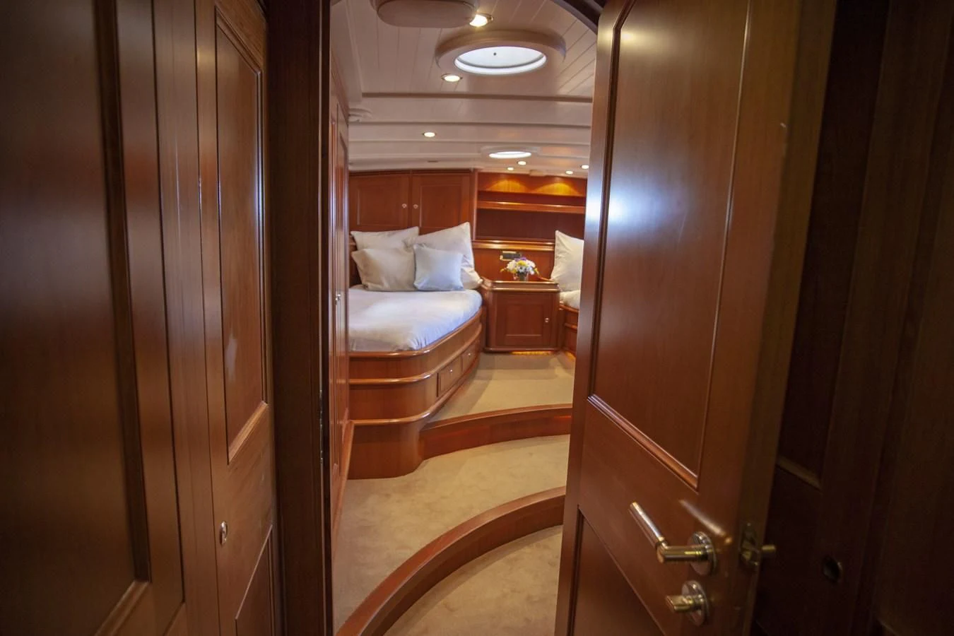 a room with a bed and a mirror aboard SWEET EMOTION Yacht for Sale