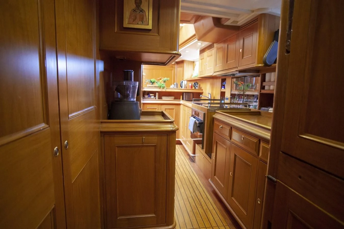 a kitchen with wooden cabinets aboard SWEET EMOTION Yacht for Sale